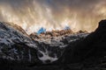 The top of the snowy mountain is covered with dark clouds Royalty Free Stock Photo