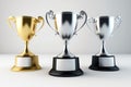 Top 3 spots winners trophies gold, silver and bronze in white background. Created with Generative AI technology. Royalty Free Stock Photo