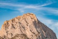 Top of stone mountain in close-up on in against blue sky