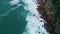 Top stormy ocean breaking on coastal stones with foam. Aerial sea crashing coast Royalty Free Stock Photo