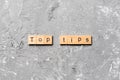 Top tips word written on wood block. Top tips text on cement table for your desing, Top view concept Royalty Free Stock Photo