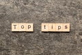 Top tips word written on wood block. Top tips text on cement table for your desing, Top view concept Royalty Free Stock Photo