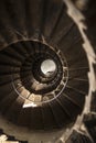 A top to bottom view from upstairs of a metal winding staircase