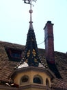 Beautiful well-kept medieval building with a dome tower and dormers and brick chimney