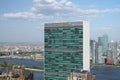 Top of United nations secretariat building with puffy white clouds above it