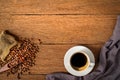 Top view above of Black hot coffee for morning with milk foam for morning menu in white ceramic cup with coffee beans roasted in b Royalty Free Stock Photo