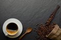 Top view above of Black hot coffee for morning with milk foam for morning menu in white ceramic cup with coffee beans roasted in s Royalty Free Stock Photo