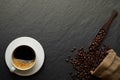 Top view above of Black hot coffee for morning with milk foam for morning menu in white ceramic cup with coffee beans roasted in s Royalty Free Stock Photo