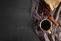 Top view above of Black hot fresh coffee in brown ceramic cup with coffee beans roasted in burlap sack bag Royalty Free Stock Photo