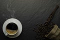 Top view above of Black hot fresh coffee with smoke and milk foam in a white ceramic cup with coffee beans roasted in burlap sack Royalty Free Stock Photo