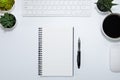 Top view from above of Blank notebook with keyboard, mouse and cup coffee on white table background. Royalty Free Stock Photo