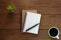 Top view from above of Blank open notebook and coffee on wood table background.