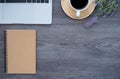 Top view above of dark wooden office desk table with keyboard and coffee cup  notebook with equipment office supplies. Royalty Free Stock Photo