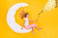 Top view above high angle flat lay flatlay lie concept view of blonde little small dreamy girl siting on white moon Royalty Free Stock Photo
