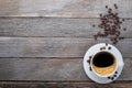 Top view, above from of Hot fresh black coffee with milk foam for morning menu in white ceramic cup with coffee beans roasted on r Royalty Free Stock Photo