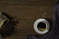 Top view above of Hot fresh black coffee with smoke and milk foam in a white ceramic cup with coffee beans roasted in sack bag on Royalty Free Stock Photo