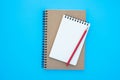 Top view above of open blank spiral notebook and red pencil isolated on light blue background for design mockup. Royalty Free Stock Photo