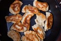 Top view above preparing traditional meal in the frying pan. Old Polish dish pirogi. Food preparing concept image.