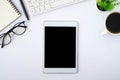 Top view above of tablet blank monitor black screen on white office desk table Royalty Free Stock Photo
