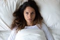 Top view unhappy annoyed woman lying in bed, insomnia concept
