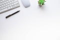 Top view above of White office desk table with keyboard, notebook and mouse with equipment other office supplies. Royalty Free Stock Photo