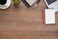 Top view above of Wooden office desk table with keyboard laptop computer and notebook with equipment other office supplies. Royalty Free Stock Photo