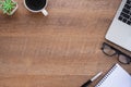 Top view above of Wooden office desk table with keyboard, notebook and coffee cup with equipment other office supplies. Royalty Free Stock Photo