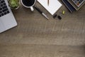 Top view above of wooden office desk table with laptop, notebook and coffee cup with equipment other office supplies. Royalty Free Stock Photo