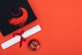 Top view of academic cap, diploma and apple on red surface. Royalty Free Stock Photo