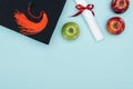 Top view of academic cap, diploma and apples on blue surface. Royalty Free Stock Photo