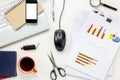 Top view accessories office desk concept.mobile phone,coffee,notepaper,pen,laptop,eyeglasses,chart on white office desk.