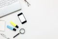 Top view accessories office desk concept.mobile phone,notepaper,pen,laptop,eyeglasses on white office desk. Royalty Free Stock Photo