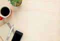 Top view accessories office desk the mobile phone,note paper,pen,coffee on wooden office desk background. Royalty Free Stock Photo