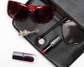 Top view accessories for woman. Stylish sunglasses, black leather bag , lipstick , perfume , fashion flat lay on white Royalty Free Stock Photo