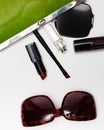 Top view accessories for woman. Stylish sunglasses, green bag , lipstick , perfume , fashion flat lay on white Royalty Free Stock Photo