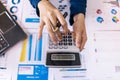 Top view. Accountant or business woman holding calculator and press button of calculator to calculate expenses, Accounting, Royalty Free Stock Photo