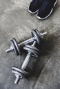 top view of adjustable dumbbells with sneakers