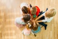 Children sitting together on a floor in a close circle