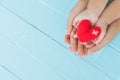 Top view of adult and child holding red heart in hands Royalty Free Stock Photo