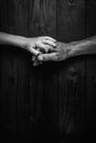 Adult hands holding kid hands, Family Help Care Concept.black and white. Royalty Free Stock Photo