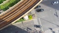 Top view aerial of a driving car on asphalt track and pedestrian crosswalk in traffic road with light and shadow silhouette with