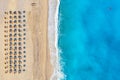 Top view aerial drone photo of Myrtos beach with beautiful turquoise water, sea waves and straw umbrellas. Vacation travel Royalty Free Stock Photo