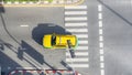 Top view aerial photo of a driving car on asphalt track and pedestrian crosswalk in traffic road with light and shadow silhouette