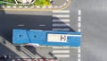 Top view aerial photo of a driving motorcycle and bus on asphalt track and pedestrian crosswalk in traffic road with light and Royalty Free Stock Photo