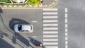 Top view aerial photo of a driving motorcycle and bus on asphalt track and pedestrian crosswalk in traffic road with light and Royalty Free Stock Photo