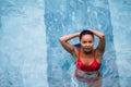 Top view aerial photo of a seductive model in white swimwear is enjoying relax in hotel pool during her summer Royalty Free Stock Photo