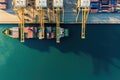 Top view, aerial view the ship container for transporting goods by sea at sea port warehouse and crane ship working for delivery