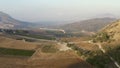 Top view or aerial shot of fresh green and yellow fields. Action. Top view of agricultural fields and mountains Royalty Free Stock Photo