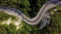 Top down view of winding mountain road with cars