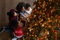 Top view African American family with children decorating Christmas tree